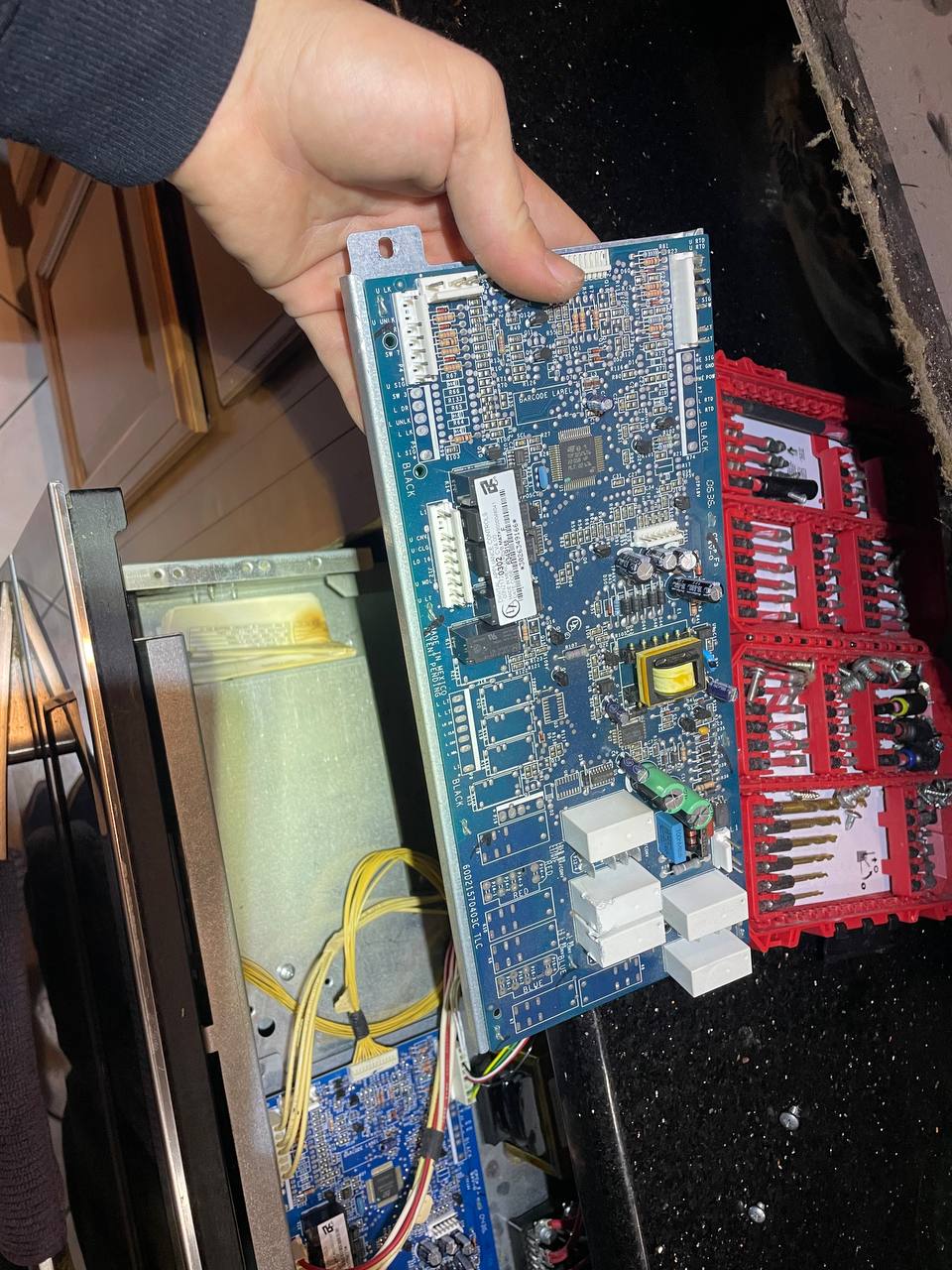 Technician repairing an appliance control board